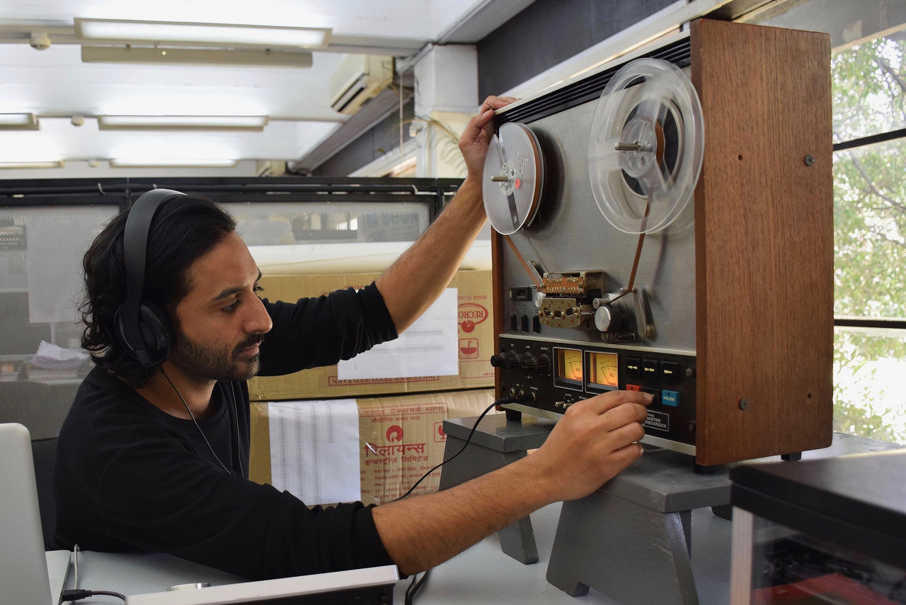 Paul Pugas examining tapes at the NID archive, 2019