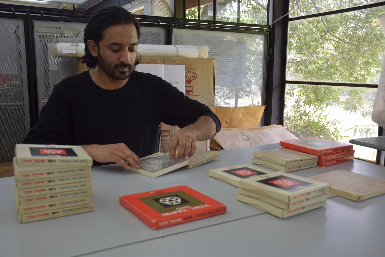 Paul Purgas working examining tapes in the NID archive, 2019
